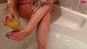 Milf seductively washing her feet in a steamy homemade display.