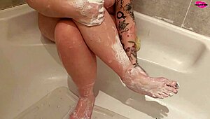 Milf seductively washing her feet in a steamy homemade display.
