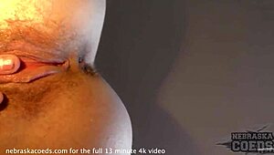 Pretty brunette tries dildo for first time on sofa.