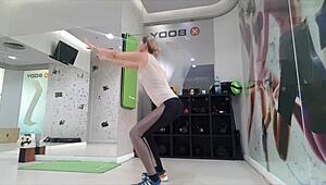 Cute blonde teen warms up at gym