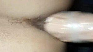 Married woman pleasuring her husband with a large sex toy