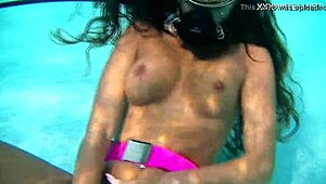 Nora Shmandora performs underwater self-sex with a purple dildo in the pool, naked and using toys.
