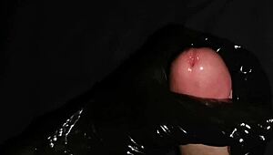 Gently masturbate horny big dick with latex gloves and lube.