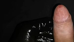 Gently masturbate horny big dick with latex gloves and lube.
