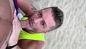 Public gay beach scene with oral sex