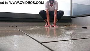 Masked babe jerks off wildly on wet balcony