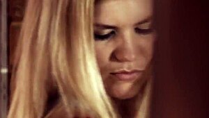 Blonde pornstar Delphine fingers her small tits while masturbating