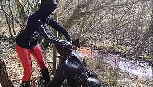 bizarre german femdom with mud and latex outdoors