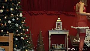 the blonde babe moans as her lesbian friend fucks her with a dildo on christmas