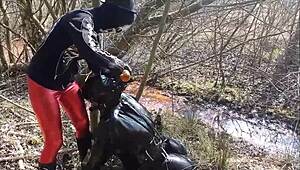bizarre german femdom with mud and latex outdoors
