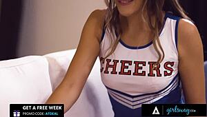 Young cheerleader gives a hot massage with oil to her teammate after the practice.