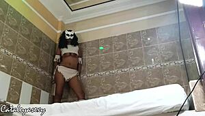 Ebony model with huge natural tits changes costume and poses seductively for the camera.