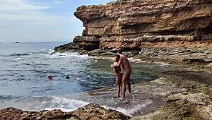 Amateurs having sex on the beach while being watched by babes