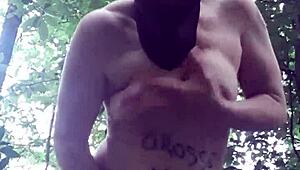 Female slave masturbates in outdoor forest bondage