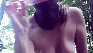 Female slave masturbates in outdoor forest bondage