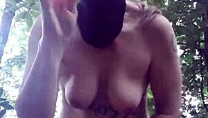 Female slave masturbates in outdoor forest bondage
