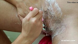 Lesbian babes shave and lick trimmed pussy in bath.