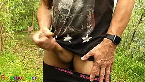 Gay guy jerks off by the lake, fingering his tight hole with monster cock