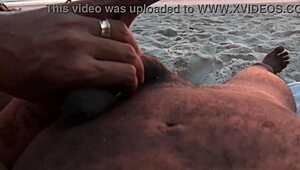 Casual couple plays risky exposure on public beach