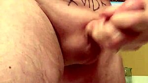 65-year-old man strokes his average cock in close-up view. His mature hands work with steady control.
