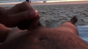 Casual couple plays risky exposure on public beach