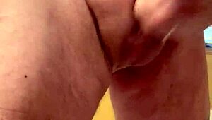 65-year-old man strokes his average cock in close-up view. His mature hands work with steady control.
