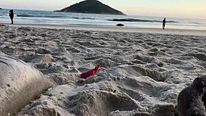 Casual couple plays risky exposure on public beach
