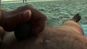 Casual couple plays risky exposure on public beach