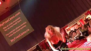 uhh, busty milf on stage strippin’ down, makin’ me crazy with them big ones, ya know?