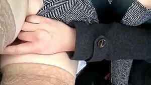 In the car, she removes her panties and pleasures herself on the street, inviting voyeurs to watch her intimate display