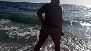 omg, im so horny watching this hot milf masturbate on the beach outside