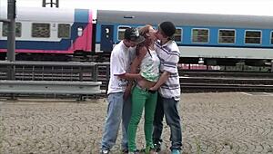 Hot 18-year-old blond joins two guys for public threesome at station.