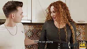 Alluring redhead stunner dives into fun with young neighbor in kitchen