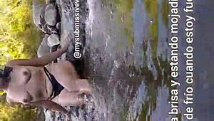 brunette exhibitionist bathes in river with tits out touching herself