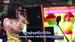 indonesian singers perform wild erotic dance on stage with eager crowd