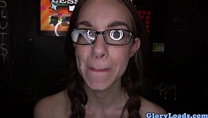 Petite babe with glasses gets down to serious cocksucking at the gloryhole