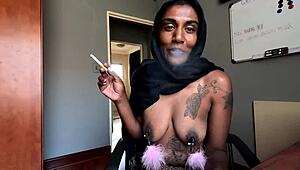 hey, check this desi in hijab smoking with nipple clamps on. wanna see more of her pierced tits?