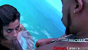 Brunette intensely sucks big cock in the pool