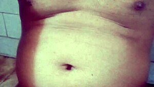 Old Indian gay bottom enjoys his own golden shower casually. He bends over for the flow.