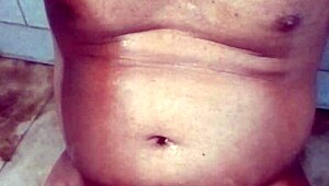 Old Indian gay bottom enjoys his own golden shower casually. He bends over for the flow.