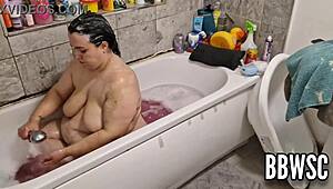 Pervert spies on BBW milf washing giant floppy tits in bath