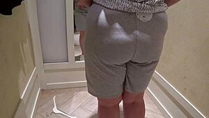 a hidden camera in the fitting room caught a mature chubby milf with a big booty trying on shorts.