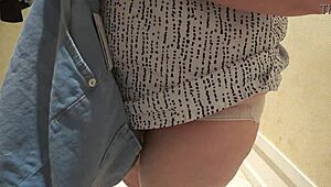 a hidden camera in the fitting room caught a mature chubby milf with a big booty trying on shorts.