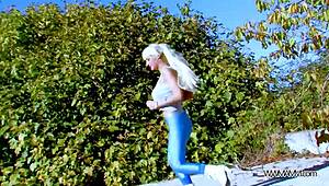 Busty fitness blonde exercises her pussy on a monster cock in public outdoor scene.