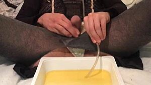 Golden piss flows from dirty old drunk