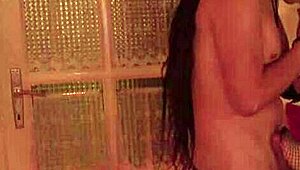 Hot scene with a brunette beauty and her big cock lover in the bedroom