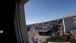 Sarada exposes big tits naked at hotel window near airport