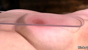 Blindfolded brunette sub endures harsh caning in tight device bondage.