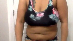 Big tit ebony milf dances in the bathroom, shaking her ass and tits around