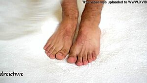 the sexy gay man shows off his huge high definition feet
